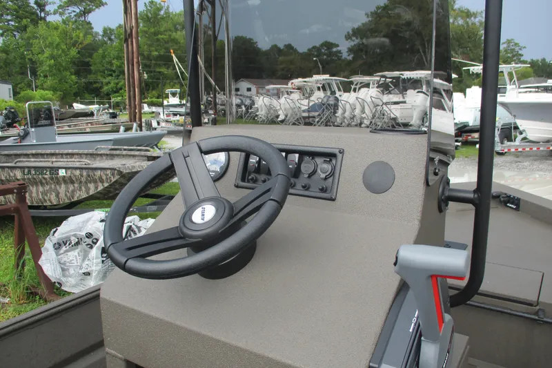 Slide: The Image of 2025 Alweld 1756 CC VV Marsh Jon boat dashboard with steering wheel and controls. - 12