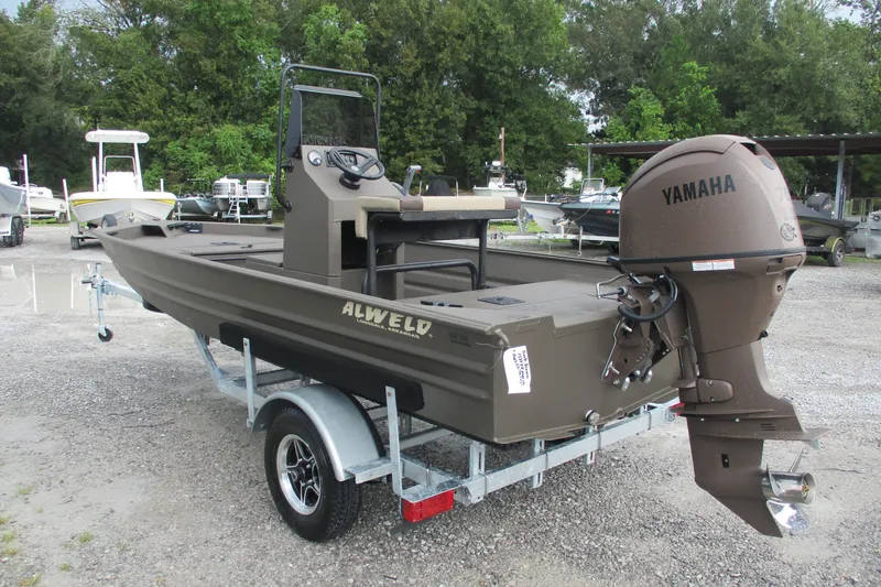 Slide: The Image of 2025 Alweld 1756 CC VV Marsh Jon boat with Yamaha motor on trailer. - 2