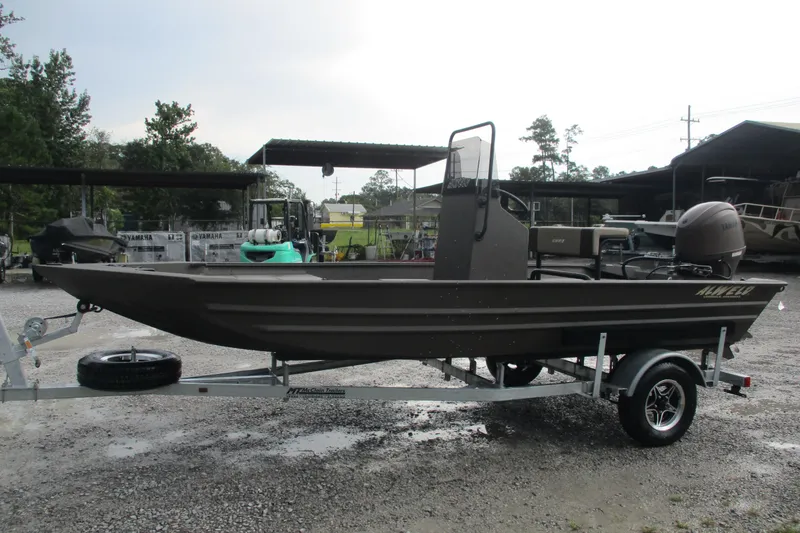 Slide: The Image of 2025 Alweld 1756 CC VV Marsh Jon boat on trailer, parked outdoors. - 4