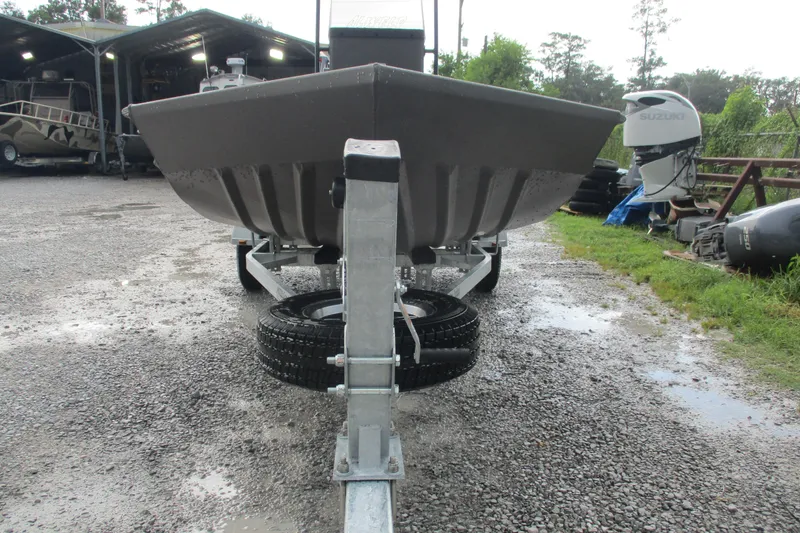 Slide: The Image of 2025 Alweld 1756 CC VV Marsh Jon boat on trailer, parked outdoors. - 7