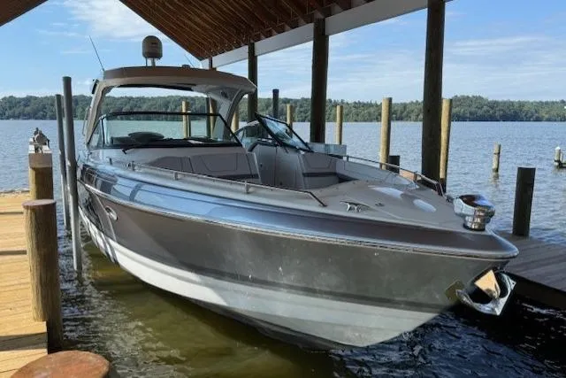 The Image of 2018 Formula 350 Crossover Bowrider OB docked under a wooden canopy. - 0