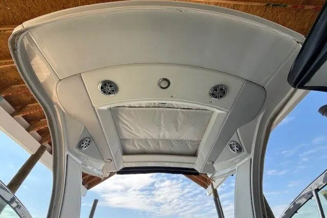 Slide: The Image of 2018 Formula 350 Crossover Bowrider OB boat canopy with speakers and sky view. - 23