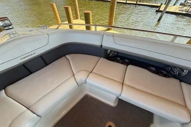 Slide: The Image of 2018 Formula 350 Crossover Bowrider OB interior with plush seating by the water. - 24
