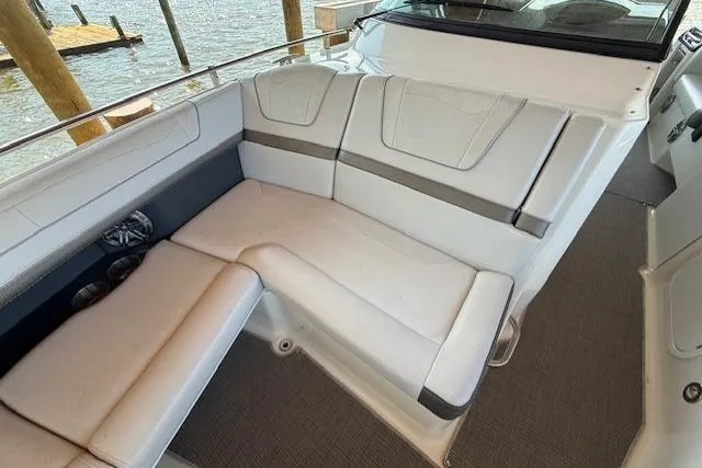Slide: The Image of 2018 Formula 350 Crossover Bowrider OB interior seating with white upholstery and waterfront view. - 25