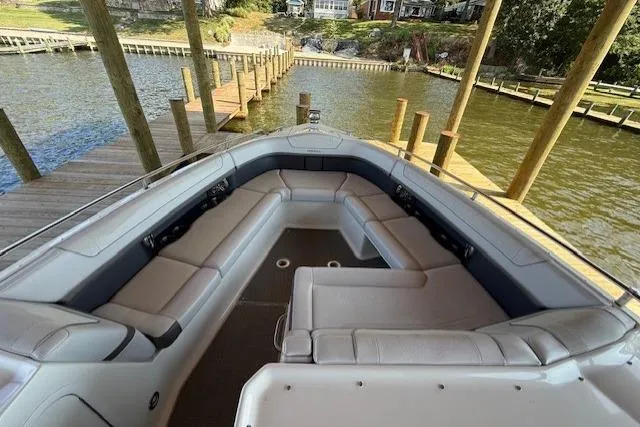 Slide: The Image of 2018 Formula 350 Crossover Bowrider OB with spacious seating at a dock. - 27