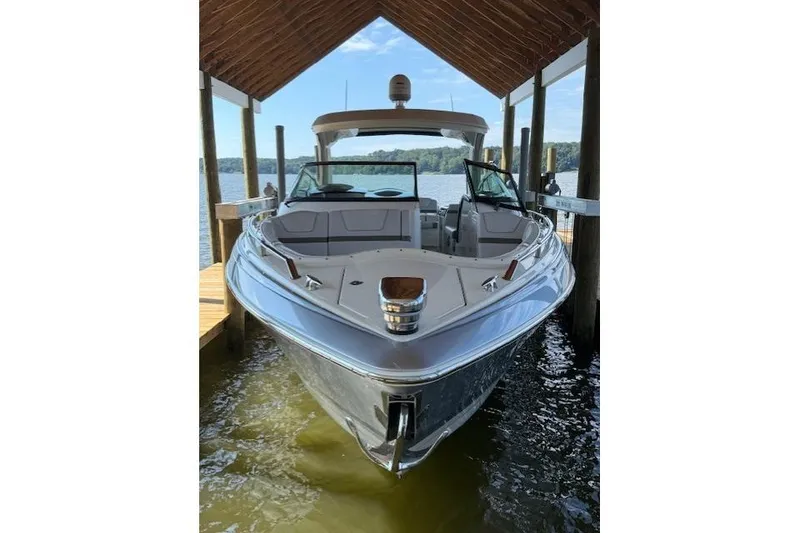 Slide: The Image of 2018 Formula 350 Crossover Bowrider OB docked under a wooden canopy. - 3