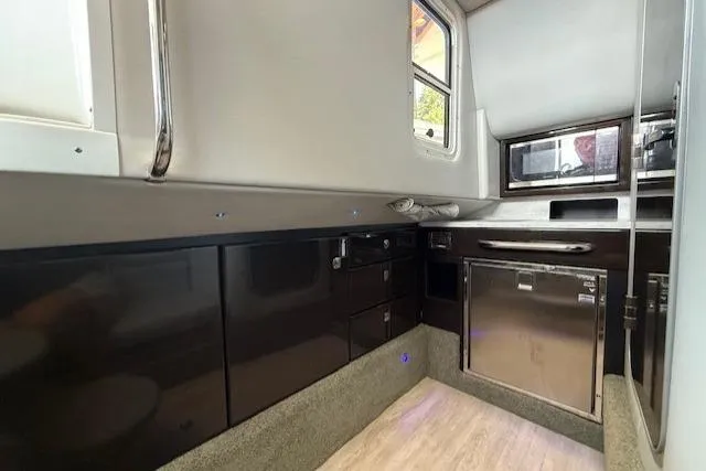 Slide: The Image of 2018 Formula 350 Crossover Bowrider OB interior with sleek cabinetry and modern appliances. - 32