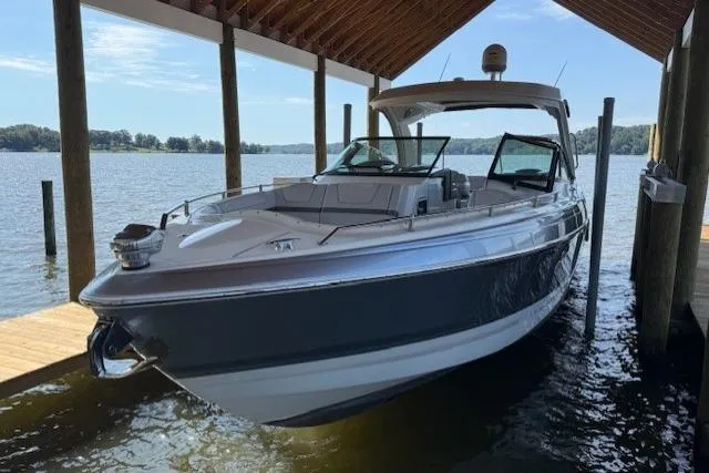 Slide: The Image of 2018 Formula 350 Crossover Bowrider OB docked under a wooden shelter. - 4