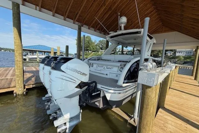 Slide: The Image of 2018 Formula 350 Crossover Bowrider OB docked under a wooden canopy. - 5