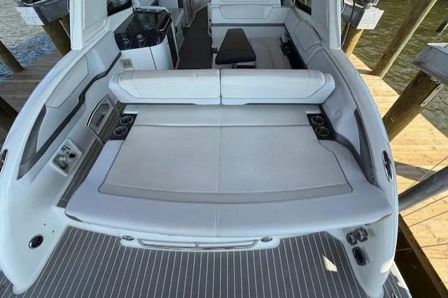 Slide: The Image of 2018 Formula 350 Crossover Bowrider OB, spacious seating, luxurious interior, docked by water. - 9