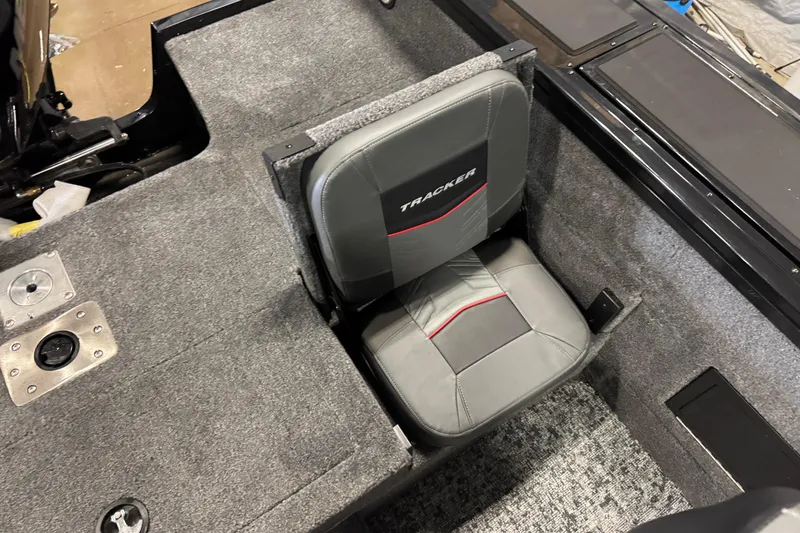 Slide: The Image of 2026 Tracker Targa V-18 Combo boat seat with gray upholstery and red accents. - 10