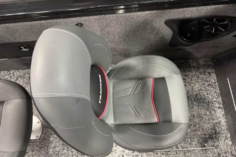 Slide: The Image of 2026 Tracker Targa V-18 Combo boat seat with gray upholstery and red accents. - 16