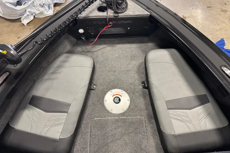 Slide: The Image of Interior of 2026 Tracker Targa V-18 Combo boat with gray seating and carpeted floor. - 18