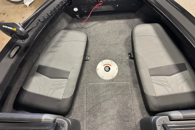 Slide: The Image of 2026 Tracker Targa V-18 Combo boat interior with gray seating and carpeted floor. - 19