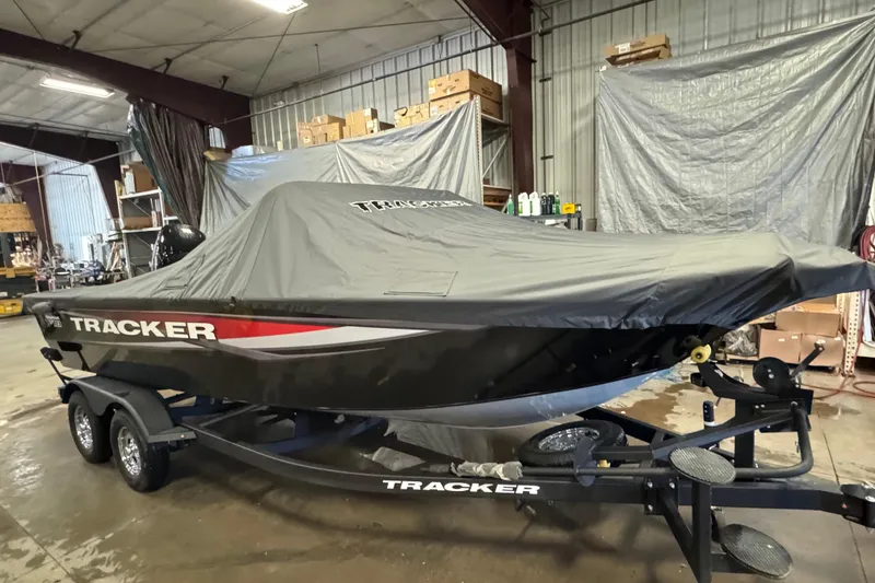 Slide: The Image of 2026 Tracker Targa V-18 Combo boat covered in a garage setting. - 22