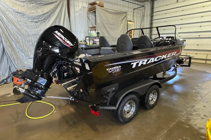 Slide: The Image of 2026 Tracker Targa V-18 Combo boat with Mercury engine in a garage setting. - 4