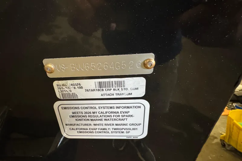 Slide: The Image of 2026 Tracker Targa V-18 Combo emissions control label and serial number plate. - 6