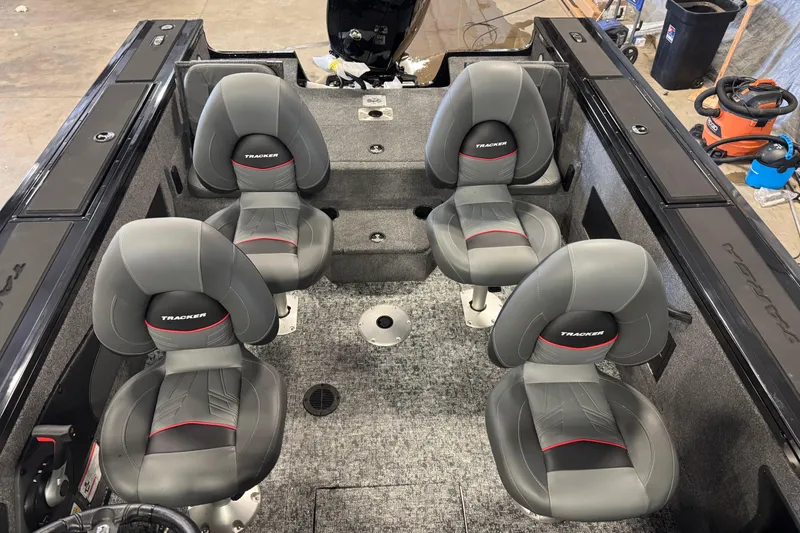 Slide: The Image of 2026 Tracker Targa V-18 Combo boat interior with four gray seats. - 7