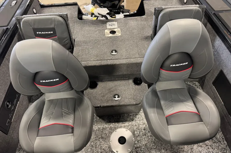Slide: The Image of 2026 Tracker Targa V-18 Combo boat interior with gray seats and red accents. - 8