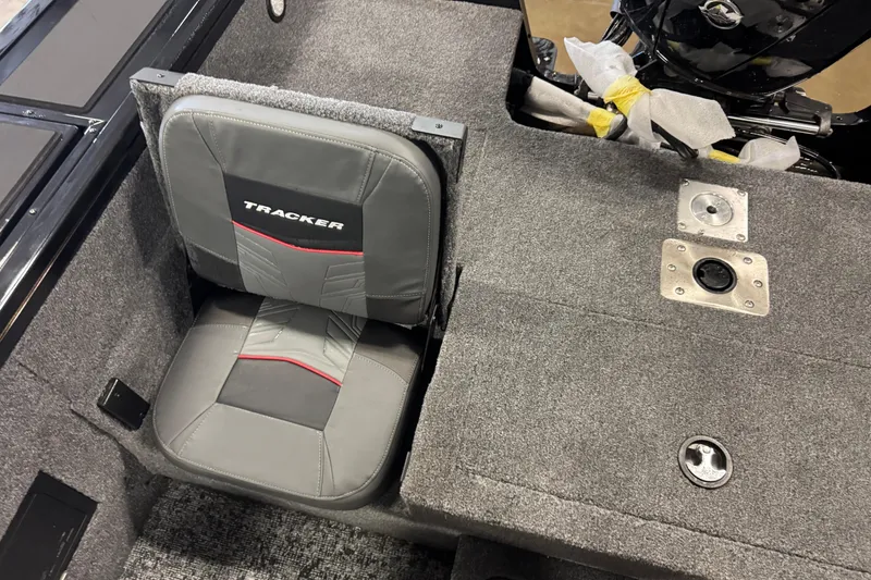 Slide: The Image of 2026 Tracker Targa V-18 Combo boat seat and deck, featuring gray upholstery and storage compartments. - 9