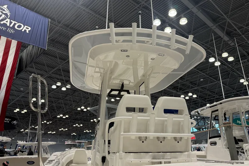 Slide: The Image of 2026 Regulator 25 boat displayed at an indoor exhibition, showcasing its sleek design and features. - 10