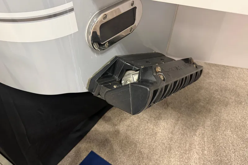 Slide: The Image of 2026 Regulator 25 boat with mounted transducer on hull, displayed indoors. - 12