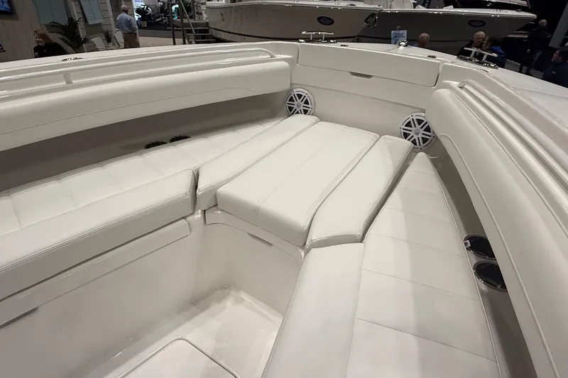 Slide: The Image of 2026 Regulator 25 boat interior with white cushioned seating and built-in speakers. - 13