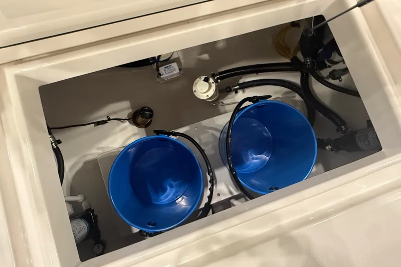 Slide: The Image of 2026 Regulator 25 boat interior with blue buckets and wiring. - 16