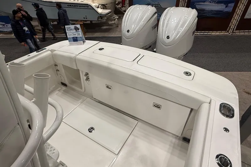 Slide: The Image of 2026 Regulator 25 boat interior with dual Yamaha engines at a boat show. - 18