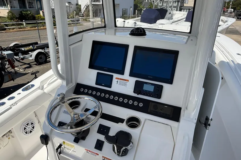 Slide: The Image of 2026 Regulator 25 boat dashboard with dual screens and steering wheel. - 19