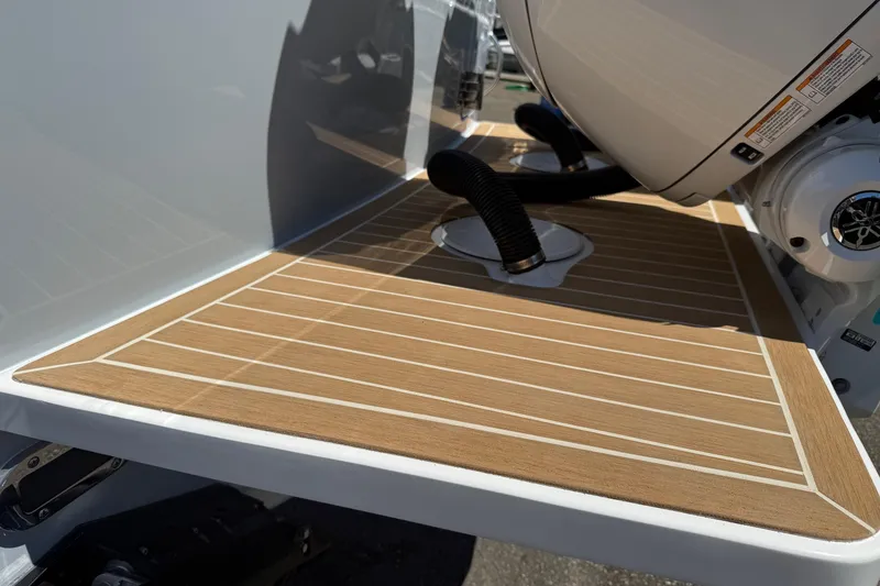 Slide: The Image of 2026 Regulator 25 boat with teak deck and engine detail. - 24