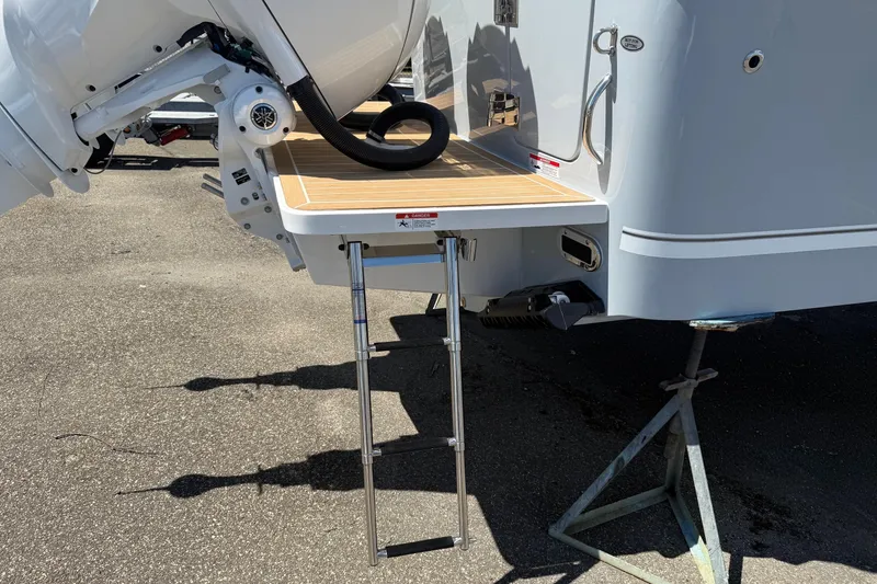 Slide: The Image of 2026 Regulator 25 boat with swim platform and ladder on a sunny day. - 27