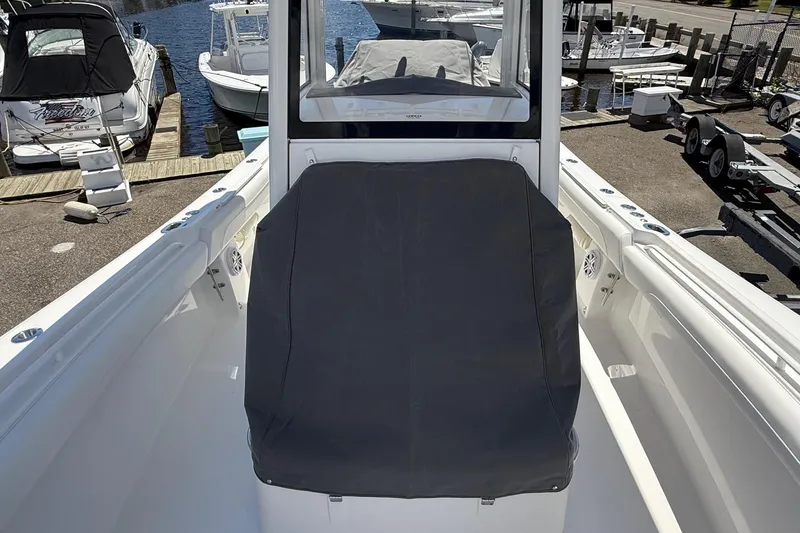 Slide: The Image of 2026 Regulator 25 boat interior with covered seating, docked at marina. - 30