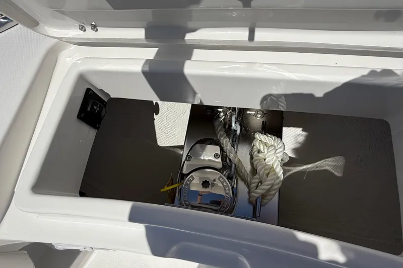 Slide: The Image of Anchor storage compartment on 2026 Regulator 25 boat, featuring rope and chain. - 33