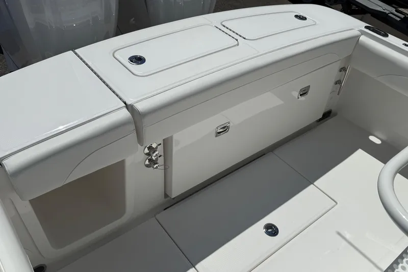 Slide: The Image of 2026 Regulator 25 boat interior with white seating and storage compartments. - 35