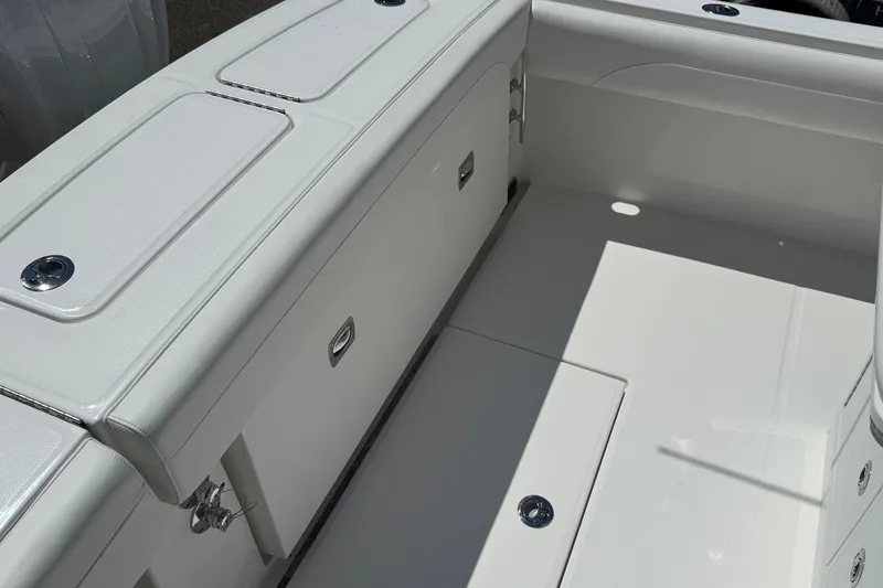 Slide: The Image of 2026 Regulator 25 boat interior with sleek white storage compartments and seating. - 38