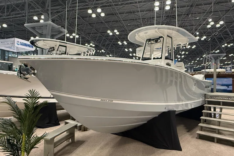 Slide: The Image of 2026 Regulator 25 boat displayed at an indoor exhibition, showcasing sleek design and modern features. - 4