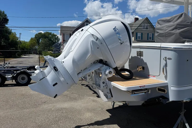 Slide: The Image of 2026 Regulator 25 boat with Yamaha outboard motor, parked outdoors on a sunny day. - 43