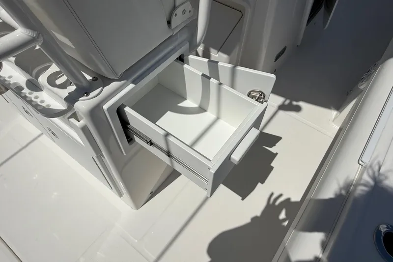 Slide: The Image of Open storage drawer on 2026 Regulator 25 boat, showcasing sleek design and functionality. - 44