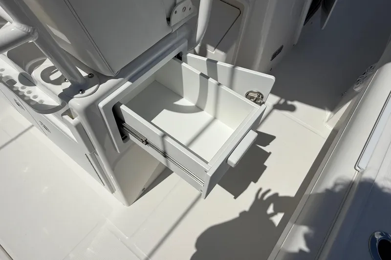 Slide: The Image of Open storage drawer on 2026 Regulator 25 boat, showcasing sleek design and functionality. - 45