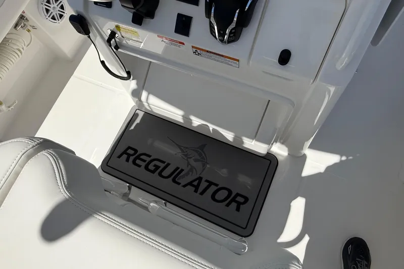 Slide: The Image of 2026 Regulator 25 boat interior with branded mat and control panel. - 46