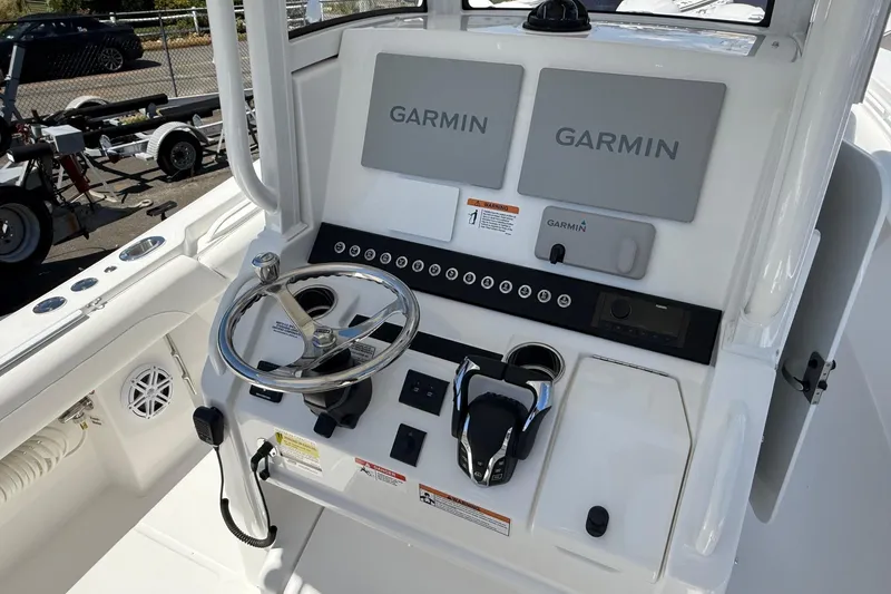 Slide: The Image of 2026 Regulator 25 boat dashboard with dual Garmin displays and steering wheel. - 47