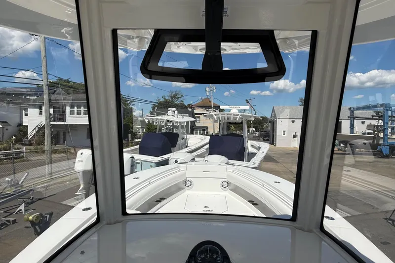 Slide: The Image of 2026 Regulator 25 boat view from cockpit, docked with clear sky background. - 49