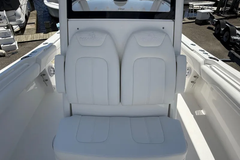 Slide: The Image of 2026 Regulator 25 boat interior with white cushioned seating and sleek design. - 51