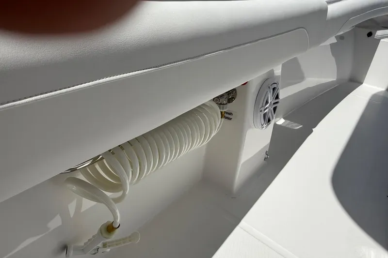 Slide: The Image of 2026 Regulator 25 boat interior with coiled hose and speaker detail. - 55