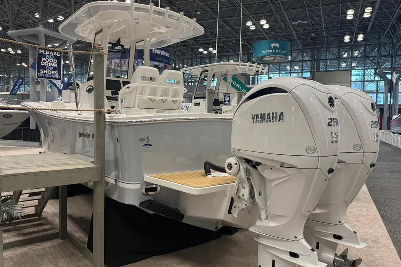 Slide: The Image of 2026 Regulator 25 boat with twin Yamaha engines displayed at an indoor boat show. - 6