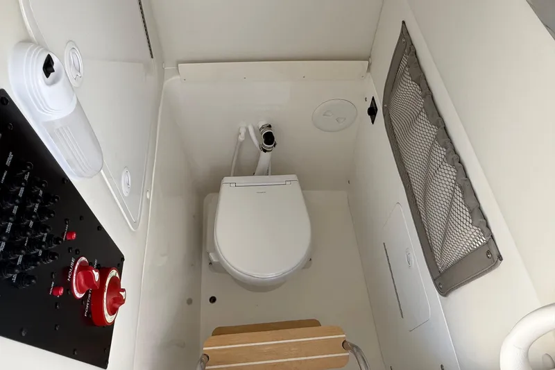 Slide: The Image of 2026 Regulator 25 boat interior with toilet and control panel. - 60