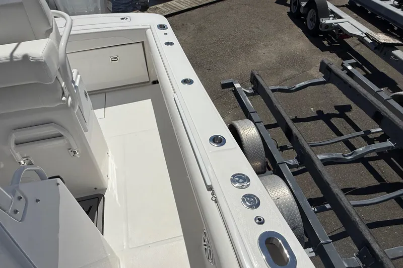 Slide: The Image of 2026 Regulator 25 boat interior with seating and trailer, showcasing sleek design and functionality. - 66