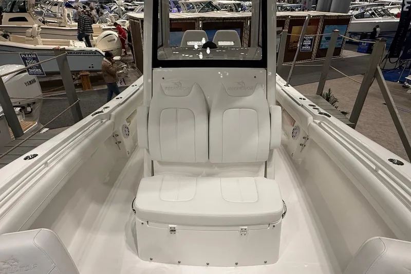 Slide: The Image of 2026 Regulator 25 boat interior with white seating at a boat show. - 73