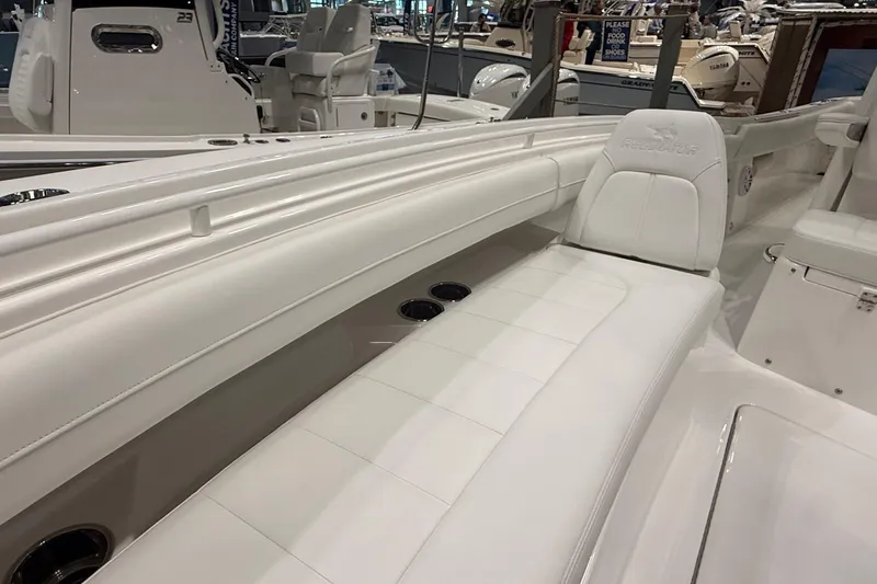Slide: The Image of 2026 Regulator 25 boat interior with white seating and cup holders. - 75